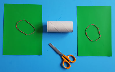 Grünes Bastelpapier wird zugeschnitten